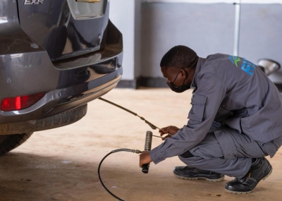 A worker conducts air pollution test at Ndera Automobile Inspection Centre on Saturday, November 22. Courtesy