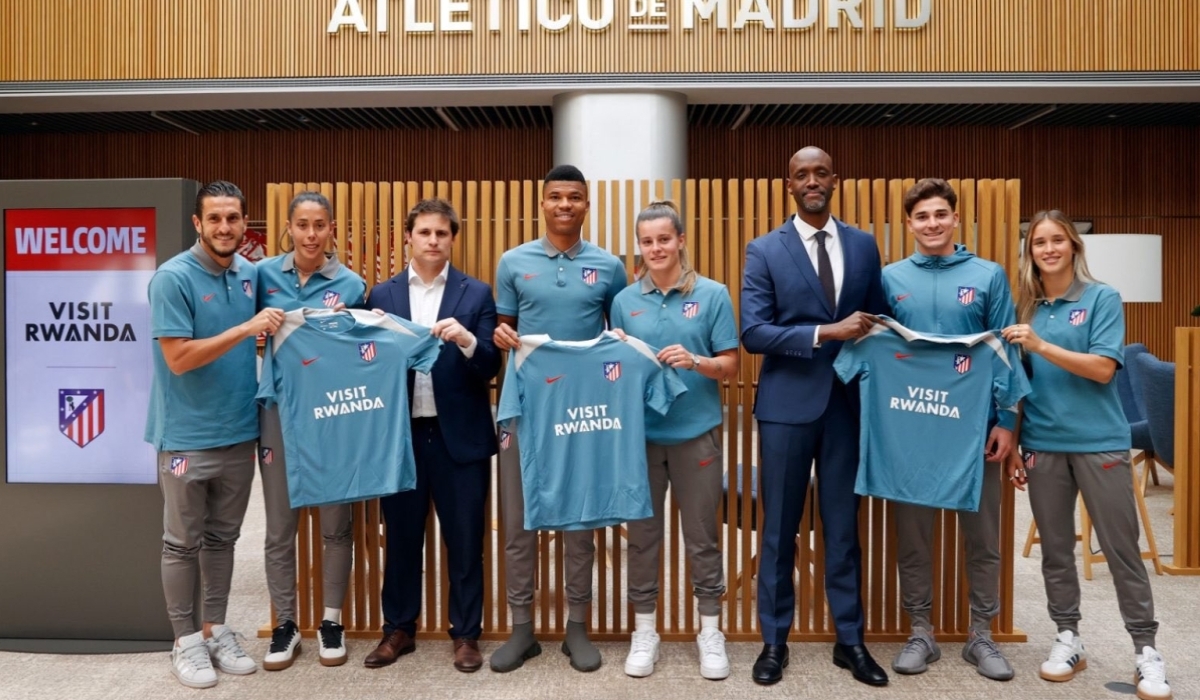 RDB CEO Jean-Guy Afrika (3rd from right) poses for a photo with Atletico Madrid players after signing a partnership agreement earlier this year.