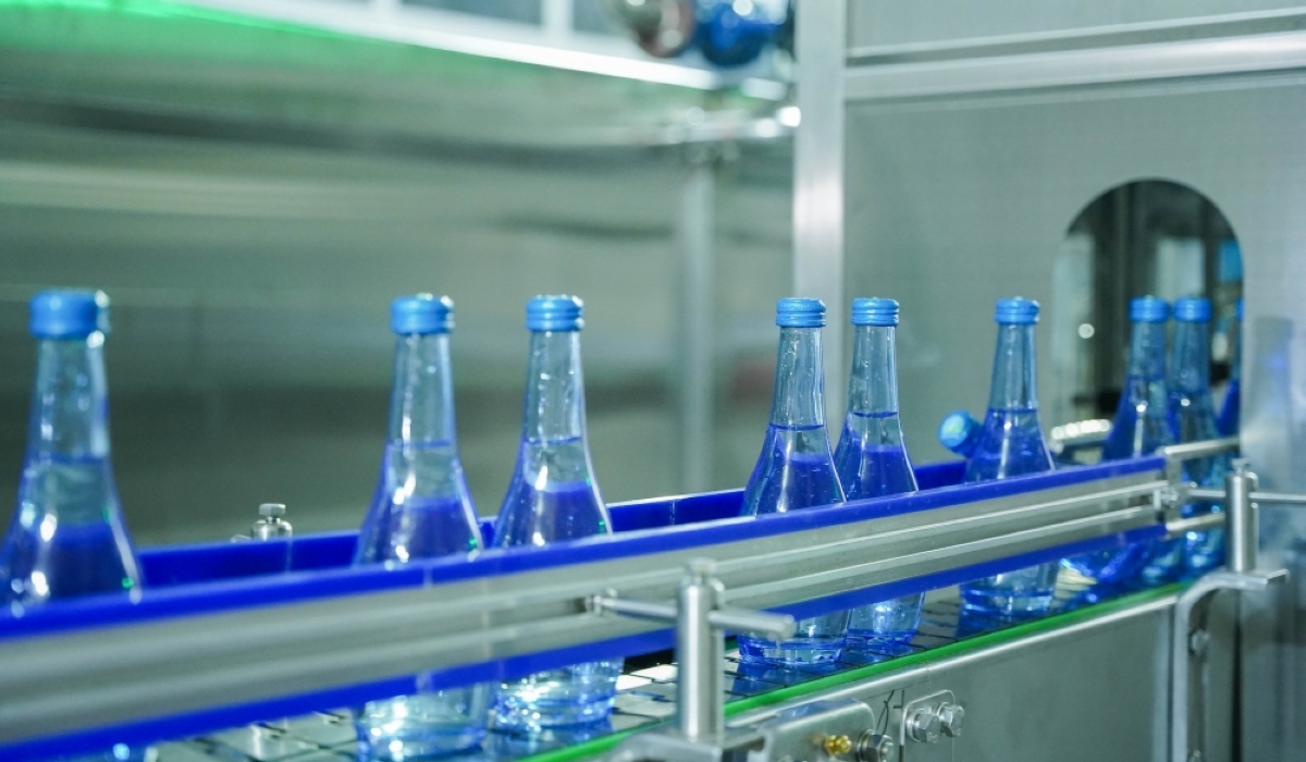 Glass water bottles in a filling production line at Inyange Industries, Kigali.