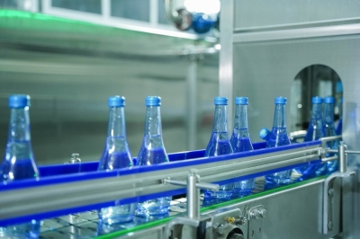 Glass water bottles in a filling production line at Inyange Industries, Kigali.