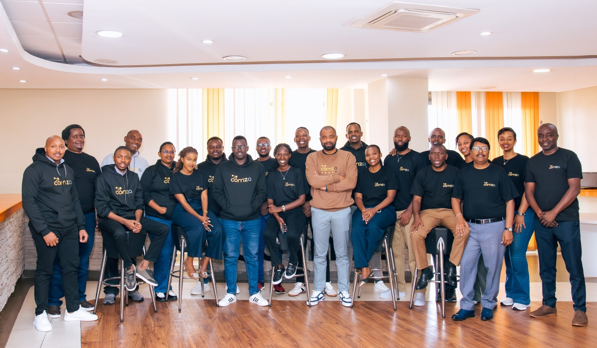 Martin Mbonu, Chief Executive Officer of ComzAfrica (center, wearing a khaki sweatshirt), poses with his colleagues. Founded in 2010 by three Rwandans, ComzAfrica has grown from addressing airtime distribution challenges to powering digital lending, payments, electricity access, and other essential utilities for millions of Africans. Courtesy