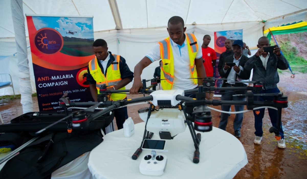 Technicians demonstrate a drone used for anti-malaria spraying during a community awareness campaign, as participants observe the technology in Kigali on November 23. Photo by Craish Bahizi
