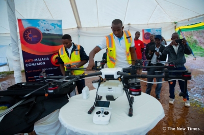 Technicians demonstrate a drone used for anti-malaria spraying during a community awareness campaign, as participants observe the technology in Kigali on November 23. Photo by Craish Bahizi