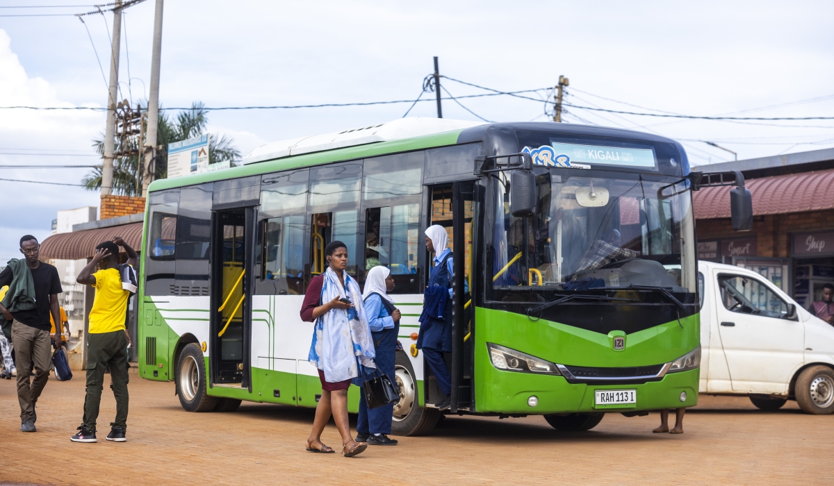 High school students board a bus in Masaka, Kigali. Private bus operators have expressed mixed reactions as the city rolls out a new service-led public transport model designed to ensure buses operate on fixed and predictable timetables for improved reliability. Photo by Olivier Mugwiza