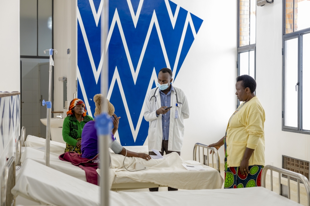 A doctor interacts with patients at Munini Hospital in Nyaruguru District in July 2022. Private insurers are preparing a series of premium adjustments and stricter monitoring measures to counter the financial strain caused by the medical tariffs that took effect on July 1. File photo