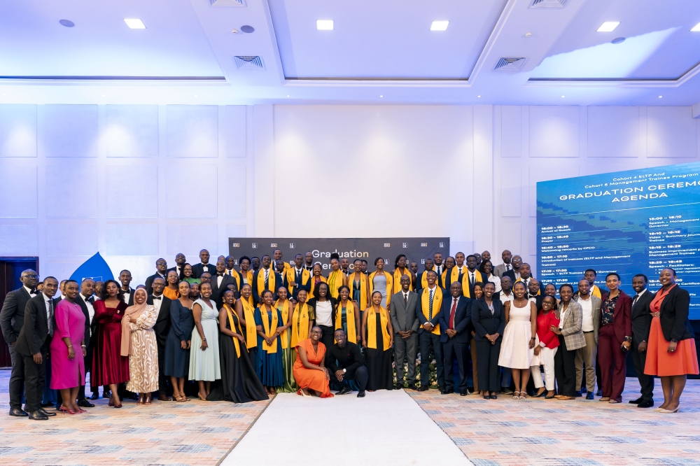 Bank of Kigali CEO, Diane Karusisi, poses with staff and graduates for a group photo during the ceremony in Kigali on December 4. 