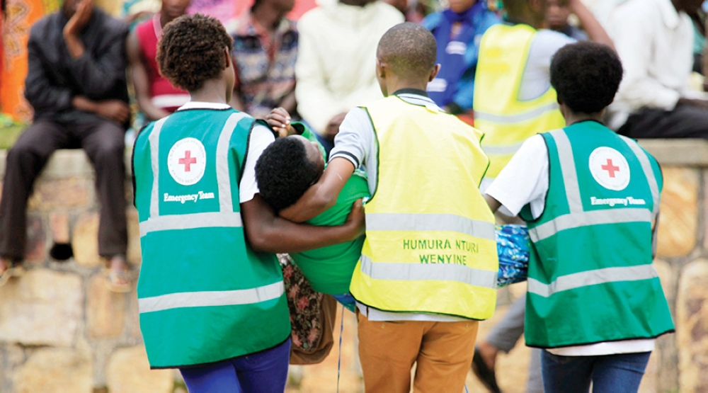 Red Cross volunteers assist a trauma victim at Kicukiro Nyanza Genocide Memorial on May 4. Mental health issues like neurosis can often go unnoticed and untreated. Courtesy