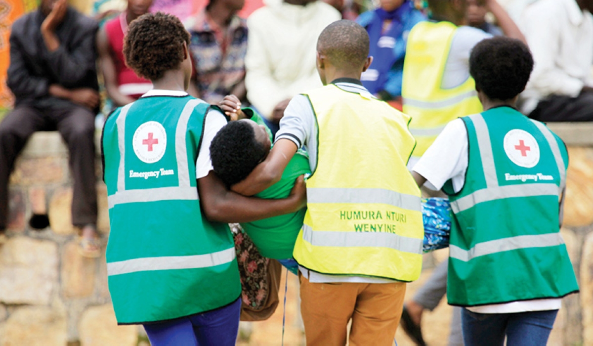 Red Cross volunteers assist a trauma victim at Kicukiro Nyanza Genocide Memorial on May 4. Mental health issues like neurosis can often go unnoticed and untreated. Courtesy