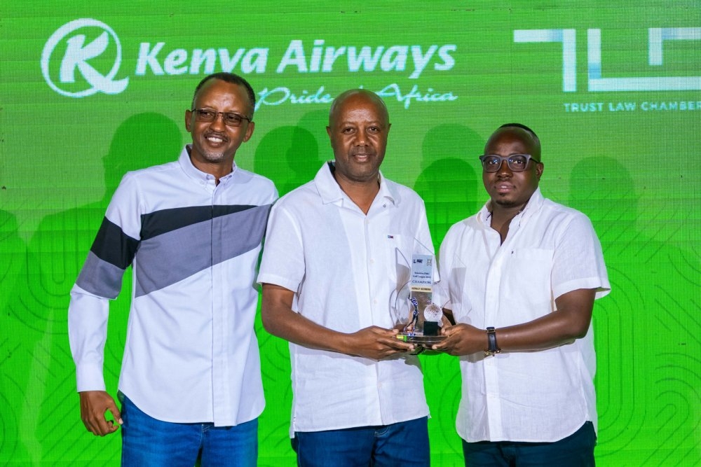 Sezibera (c) receives the PMC Gold League 2025 title from Sensitive Group CEO Wilson Mugwema (R). They were joined by Kigali Golf Club president  Marcel Byusa (L). Photo courtesy