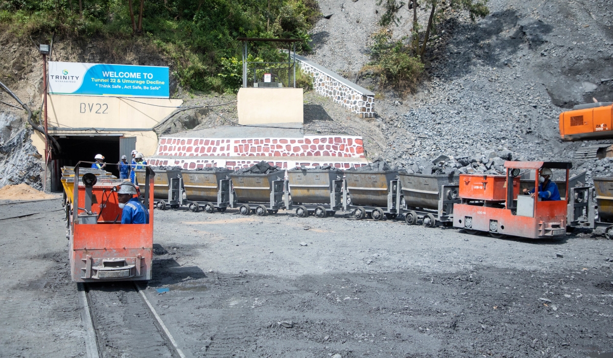 Small locomotives transport minerals out of a tunnel at Nyakabingo mining site, on December 4, 2025. Craish Bahizi