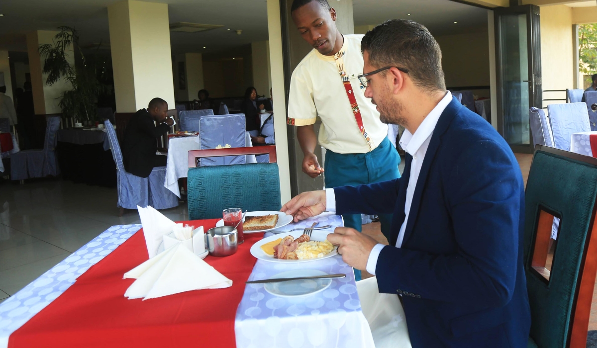 A waiter serves a client at Portofino Hotel in Kigali. Photo Sam Ngendahimana