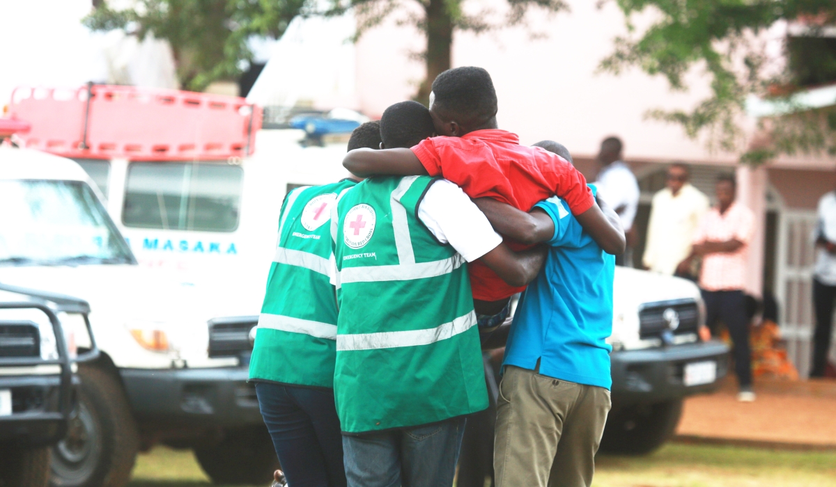 Volunteers help a trauma victim during a commemoration event at Kicukiro Nyanza Genocide Memorial on May 4, 2019.