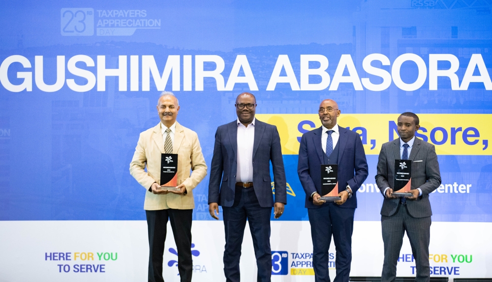 Prime Minister Justin Nsengiyumva poses for a photo with  the most compliant taxpayers during the 2025 Taxpayer Appreciation Day on December 12. Photos by Dan Gatsinzi