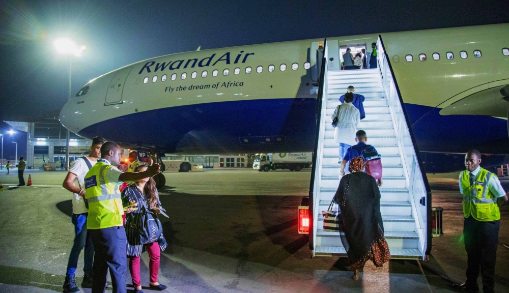 Passengers board RwandAir&#039;s plane at Kigali International Airport in 2020. 