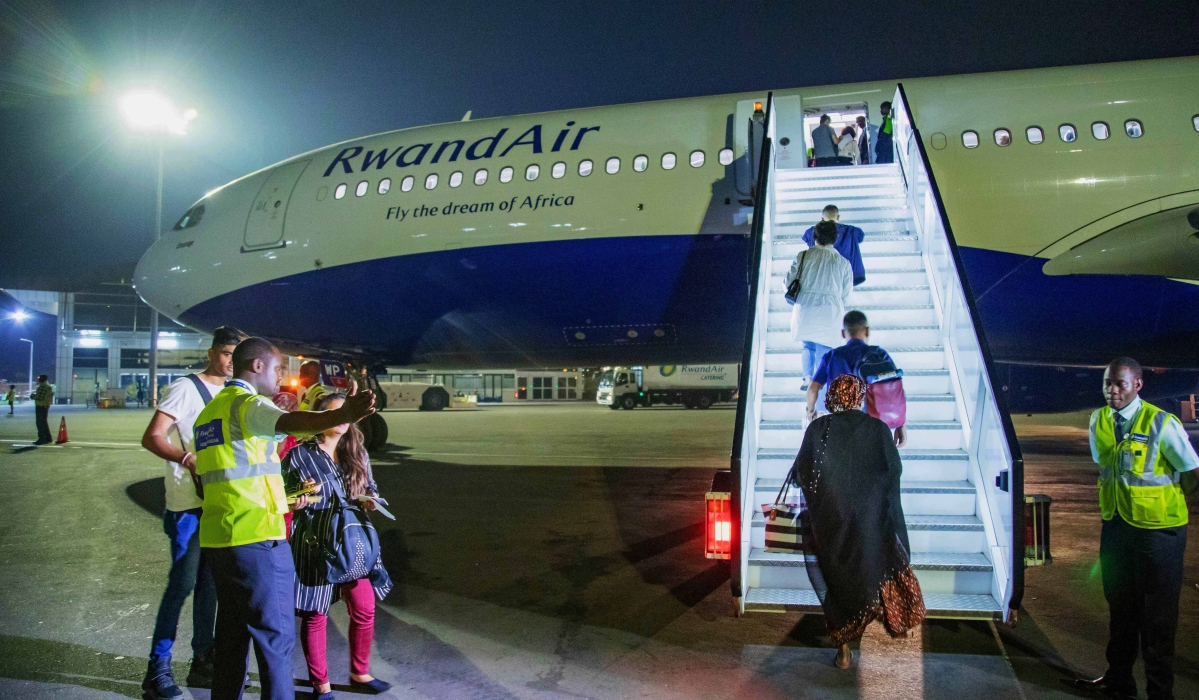 Passengers board RwandAir's plane at Kigali International Airport in 2020. 