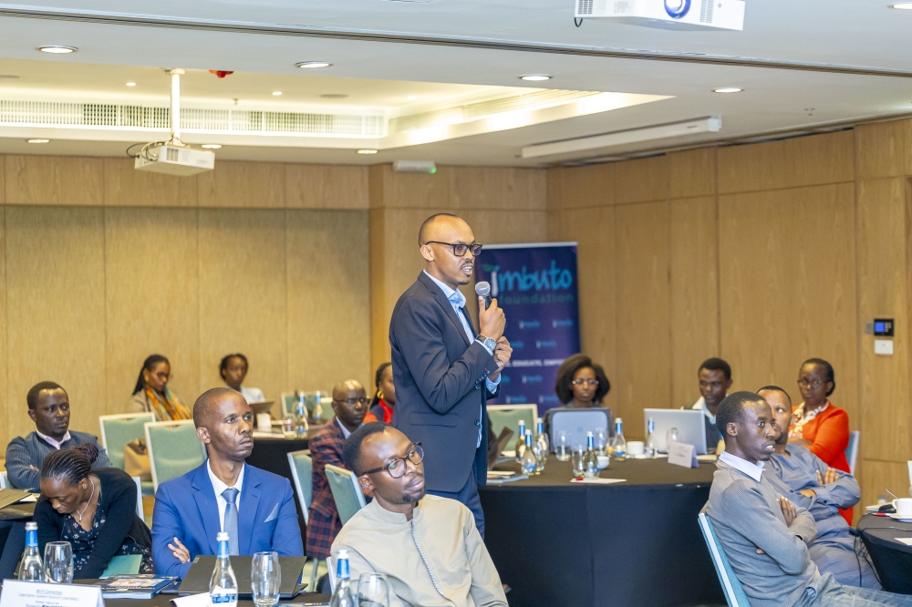 Participants follow the presentation on the newly validated  guide in Kigali on December 16. The new guide is intended for trainers who work with parents and young people in both school and community settings.