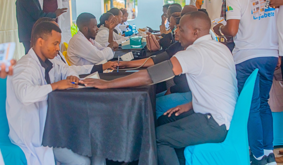Residents undergo the Community-based screening for hypertension and NCDs at Kigali Car Free Day mass sports. File