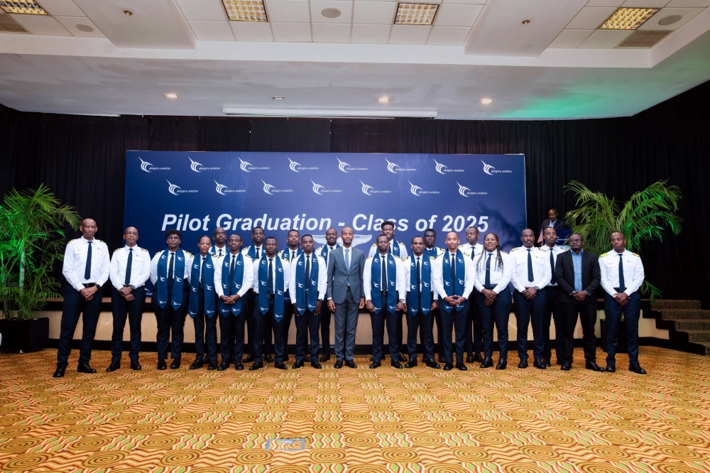 Officials pose for a group photo with the newly graduated 18 pilots of the sixth cohort from Akagera Aviation Flying School (AAFS).