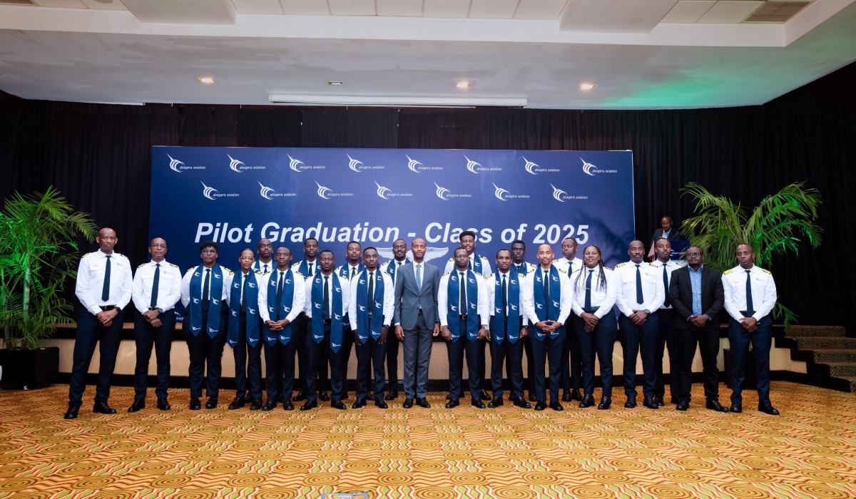 Officials pose for a group photo with the newly graduated 18 pilots of the sixth cohort from Akagera Aviation Flying School (AAFS).
