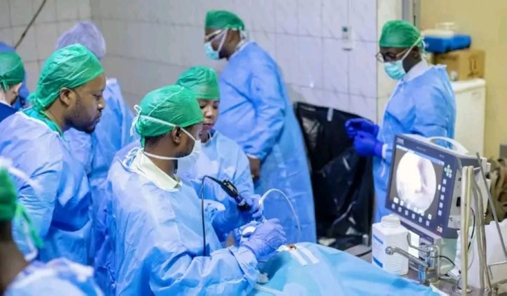 Medical professionals carry out a surgical procedure using advanced medical equipment in a hospital operating theatre in Kigali