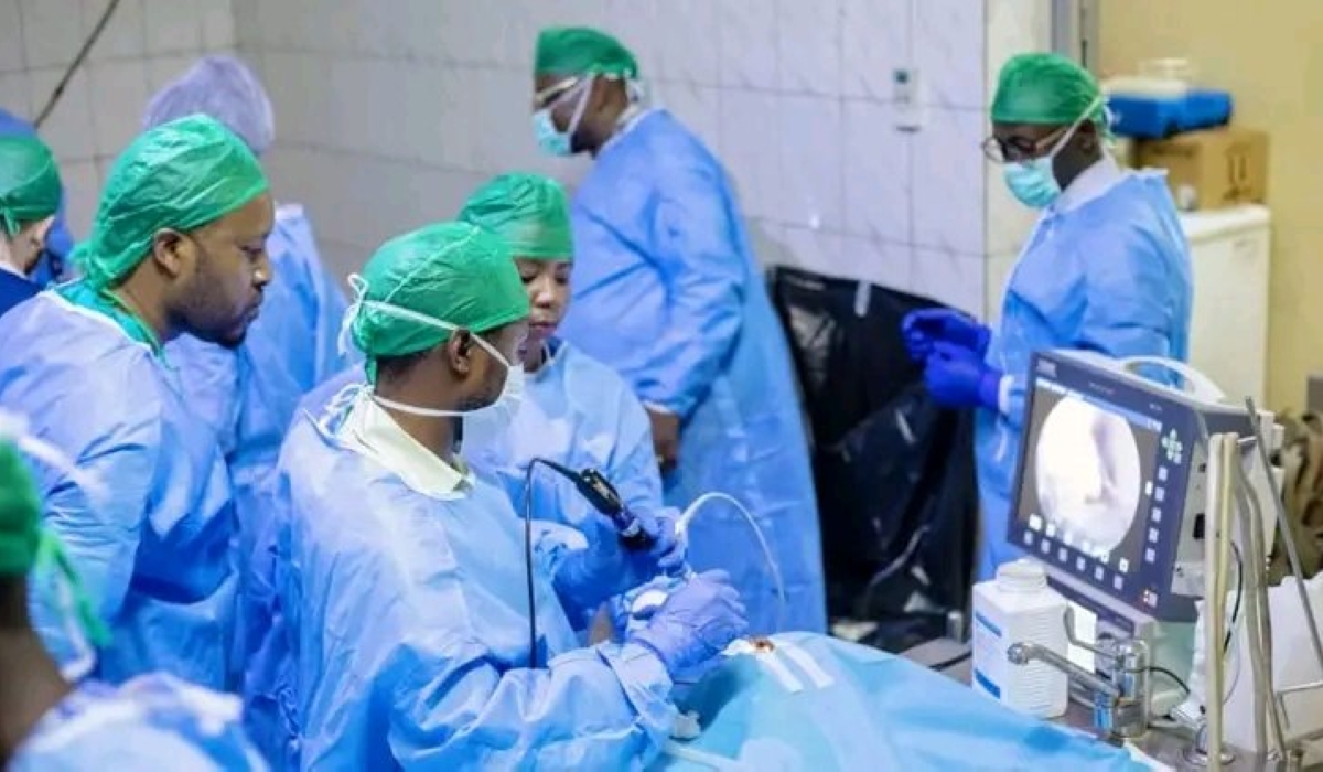 Medical professionals carry out a surgical procedure using advanced medical equipment in a hospital operating theatre in Kigali