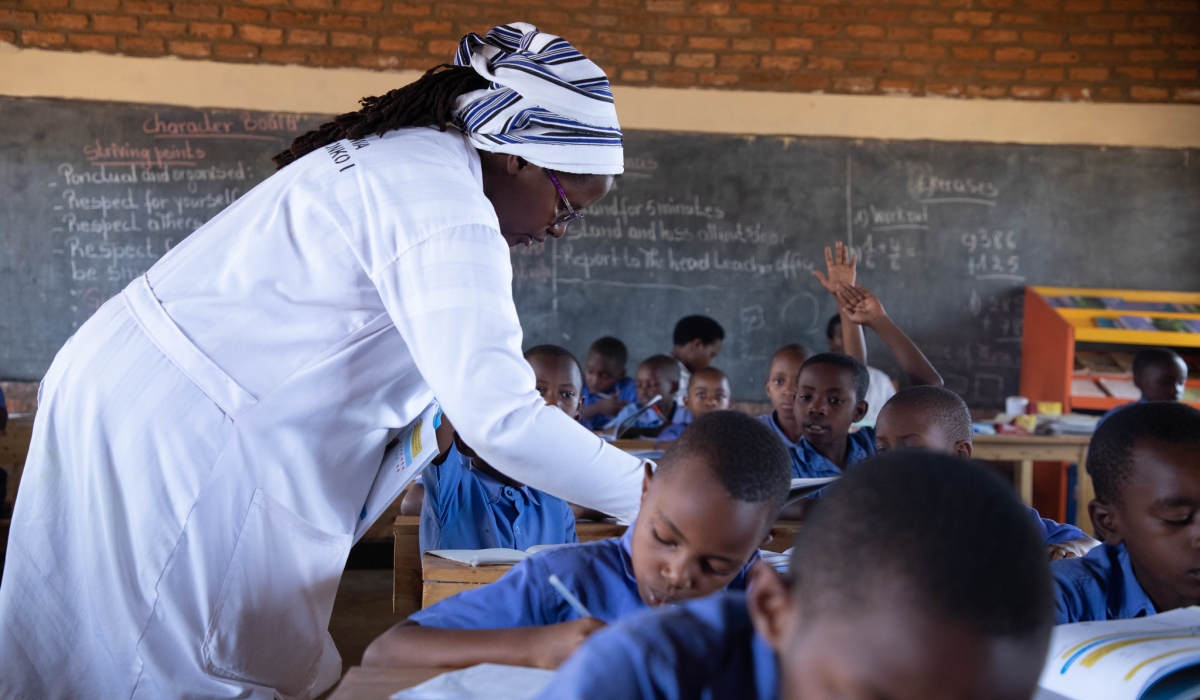 A teacher inspects her students during an English course at GS Kimisange. Dan GATSINZI