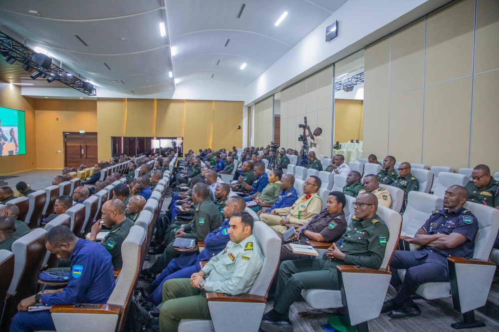 Officers and other delegates follow a panel discussion during the event.