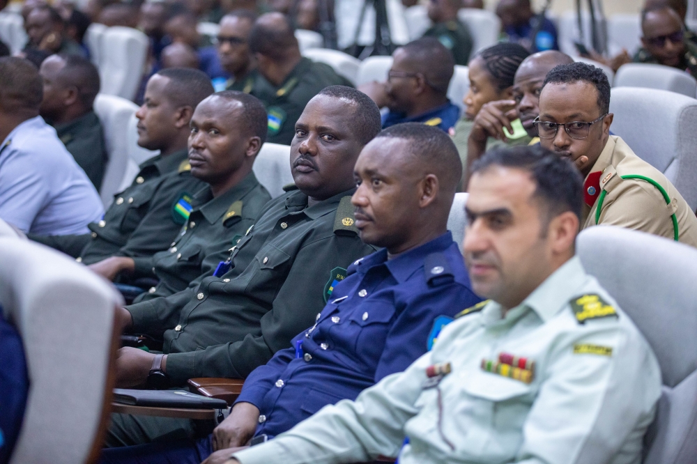Officers and other delegates follow a panel discussion during the event. Photo by Craish BAHIZI