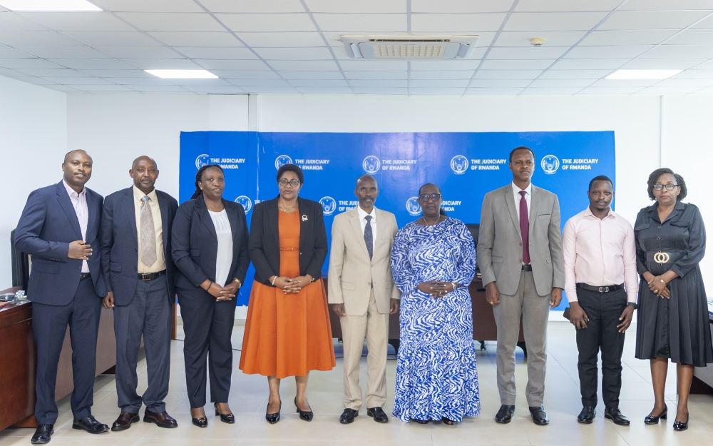 Chief Justice Domitilla Mukantaganzwa pose for a photo with outgoing committee and the new committee during the handover ceremony.