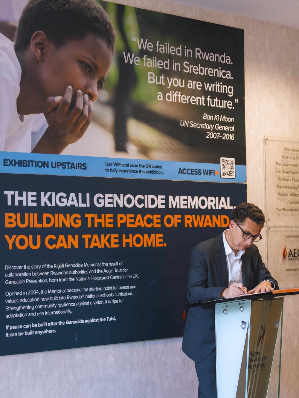 Maxime Saada writes in the guestbook at Kigali Genocide Memorial.