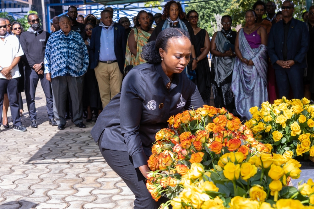 The Deputy Chief Executive Officer of the Rwanda Social Security Board, Louise Kanyonga, lays a wreath at RSSB headquarters on May 21. Courtesy