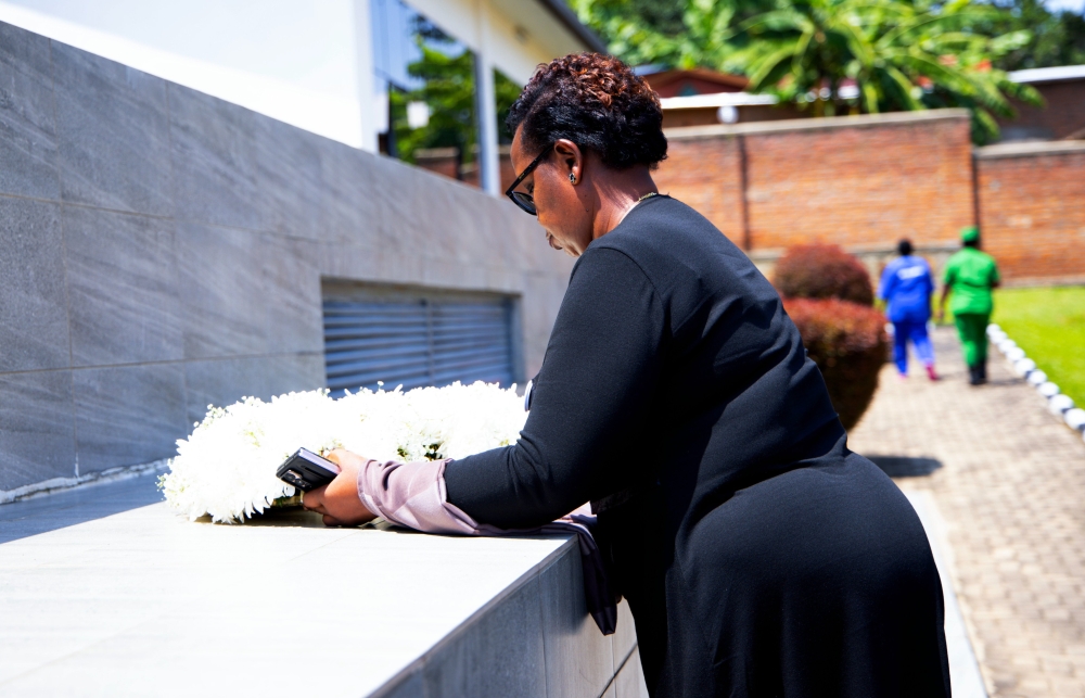 Olive Muligo, the Secretary General of the Office of the Auditor General, lays a wreath at Gatwaro Genocide Memorial in Karongi District
