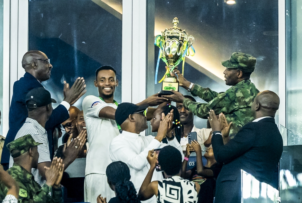 RDF Chief of Defence Staff, Gen Mubarakh Muganga, and APR FC team captain Niyomugabo celebrate the Peace Cup title