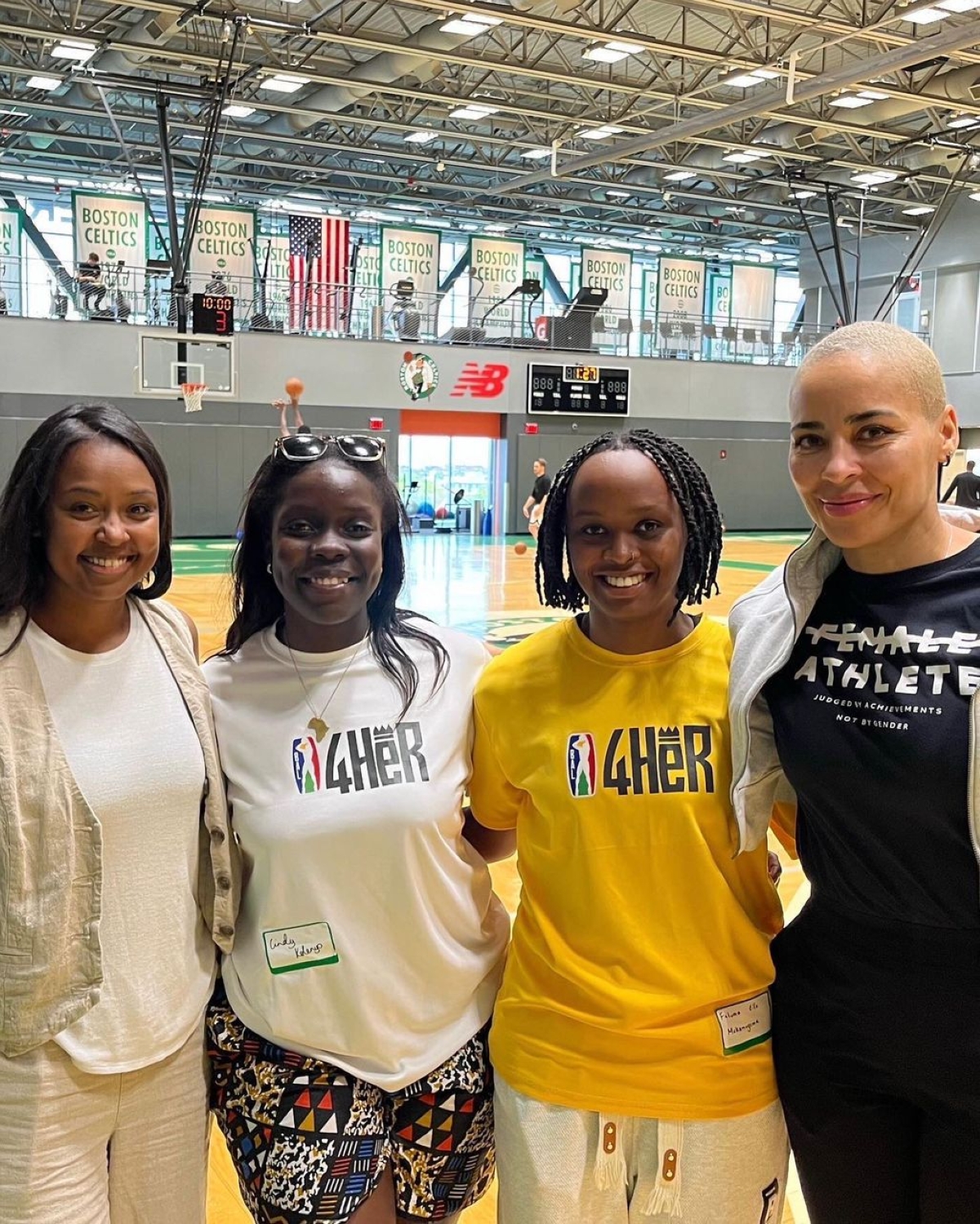 Mukamugema (in yellow shirt) taking pictures with BAL4HER participants and fellow mentor Alison Feaster in Boston (right) camp in 2023.courtesy
