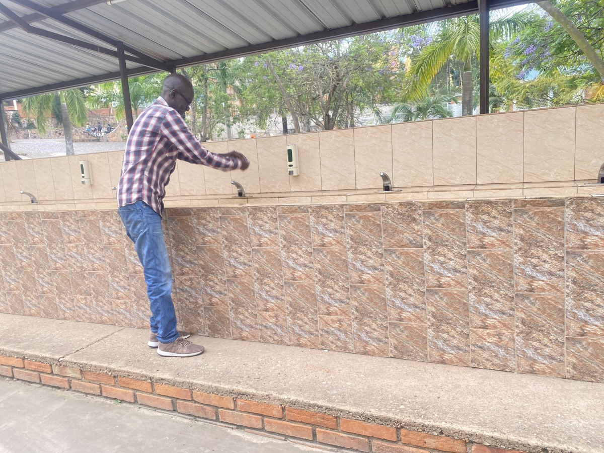 A man washes his hands at Christian Life Assembly Church in Nyarutarama