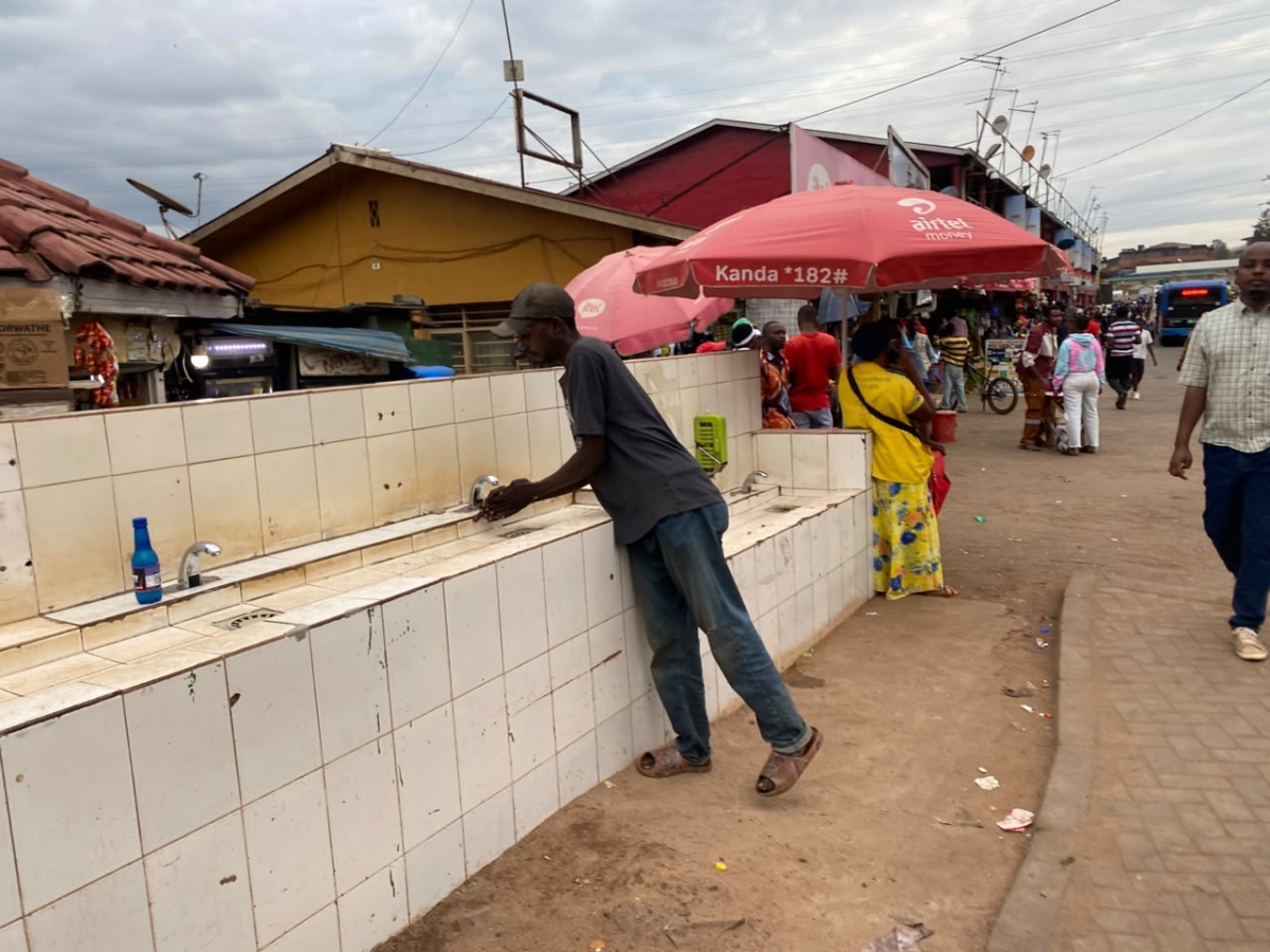 A man washes his hands at a handwashing station before entering Nyabugogo Taxi Park