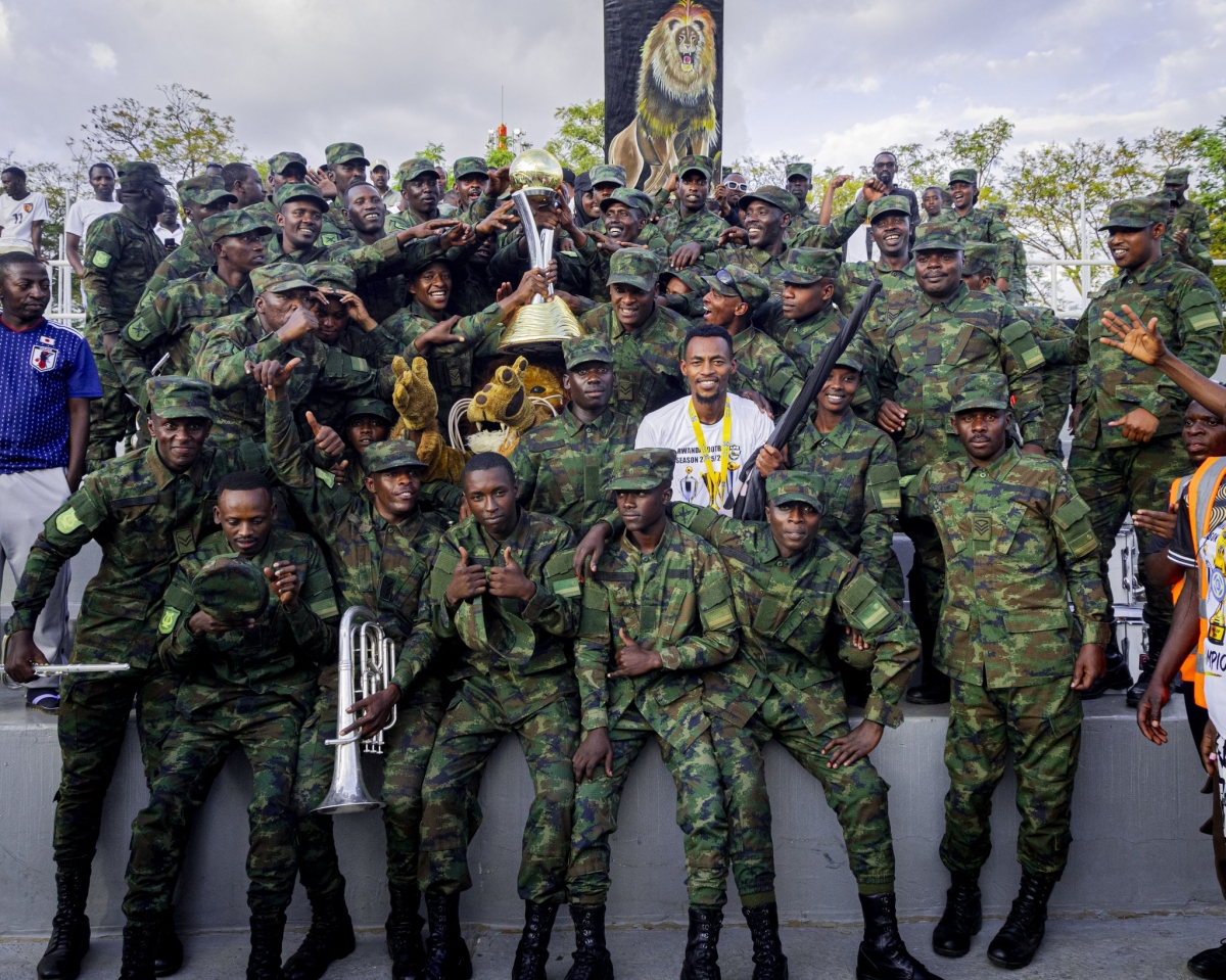 Army side captain Niyomugabo poses for a photo with team supporters during a celebration.