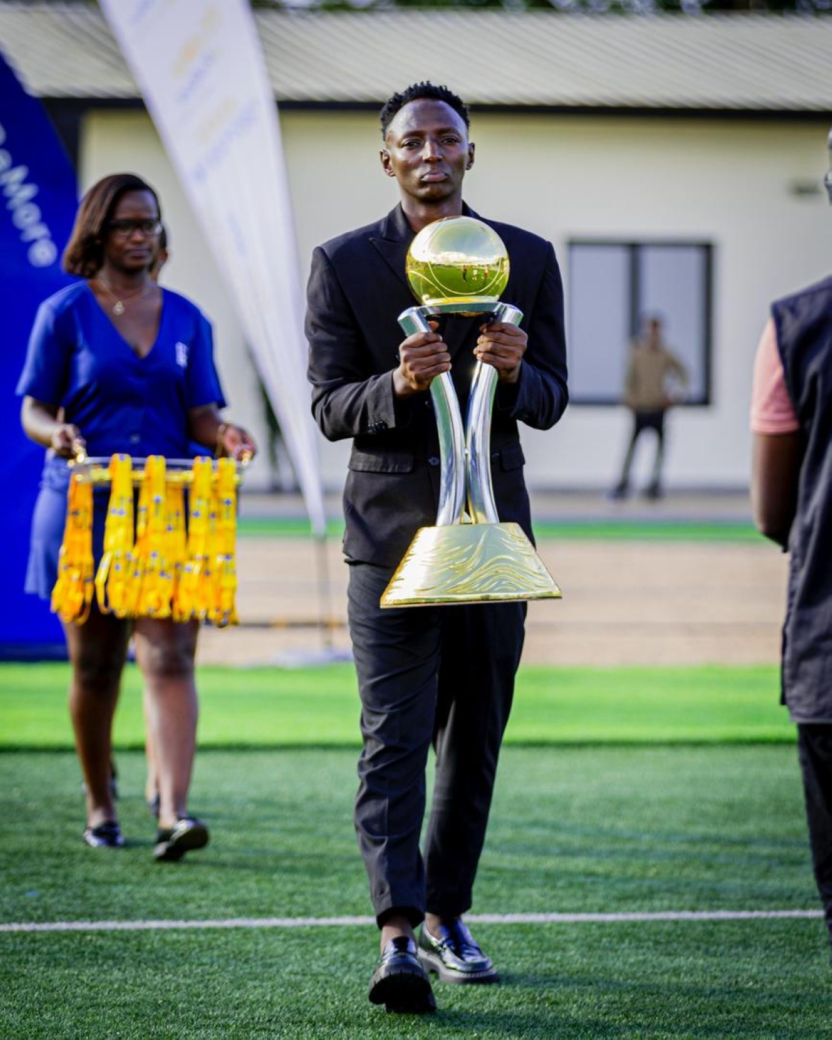 Former APR FC midfielder Andrew Buteera was entrusted to carry the BK Pro League trophy out onto the pitch before already champions APR FCfaced Gicumbi FC in the season-ending game. courtesy