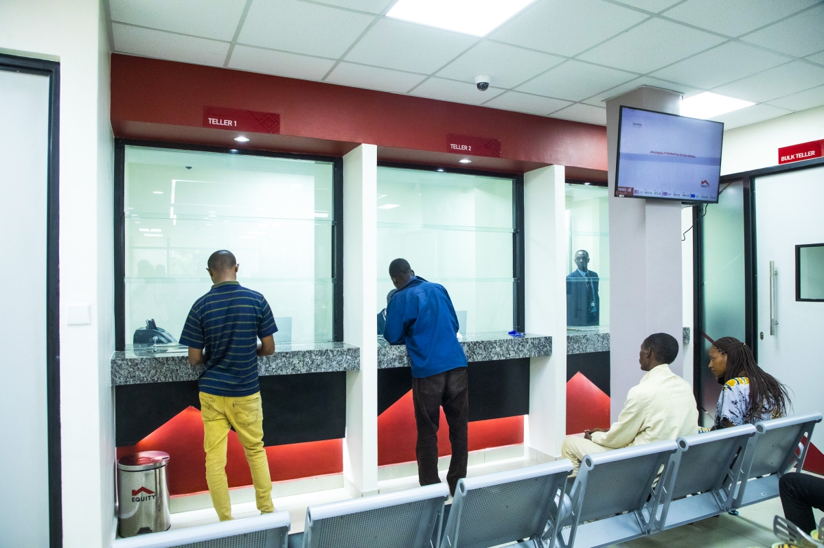 Bank tellers attend to customers at the newly opened Nyamirambo branch in Kigali.