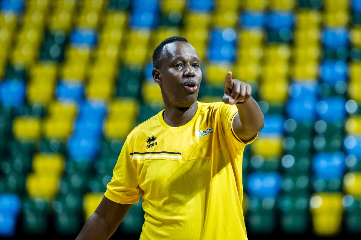 The national team coach Yves Murenzi talks to the players during a training session.