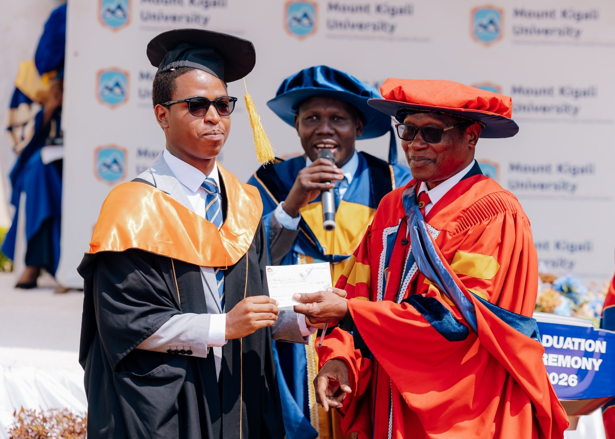 Mount Kigali University Chancellor Prof. Egara Kabaji (right) presents an award to a graduate during the graduation ceremony held in Kigali on August 7, 2026. All photos are by Craish Bahizi.jpg