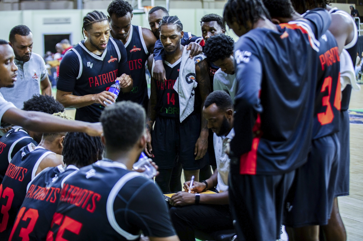 Patriots players listen to their coach during the game. Photo by Mico Elvis Ndateba