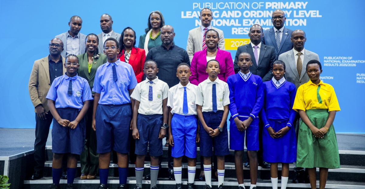 Officials pose for a group photo with the top performers of the National Examinations
