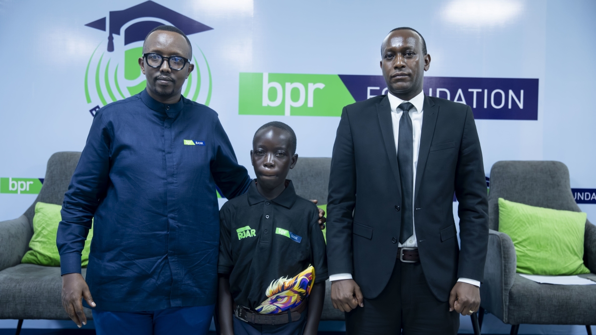 Vincent Ngirikiringo, Chief Financial Officer at BPR Bank Rwanda Plc (left), poses with BPR Scholar Patrick Shema (centre) and Eric Niyongabo, who represented the Ministry of Education at the event.