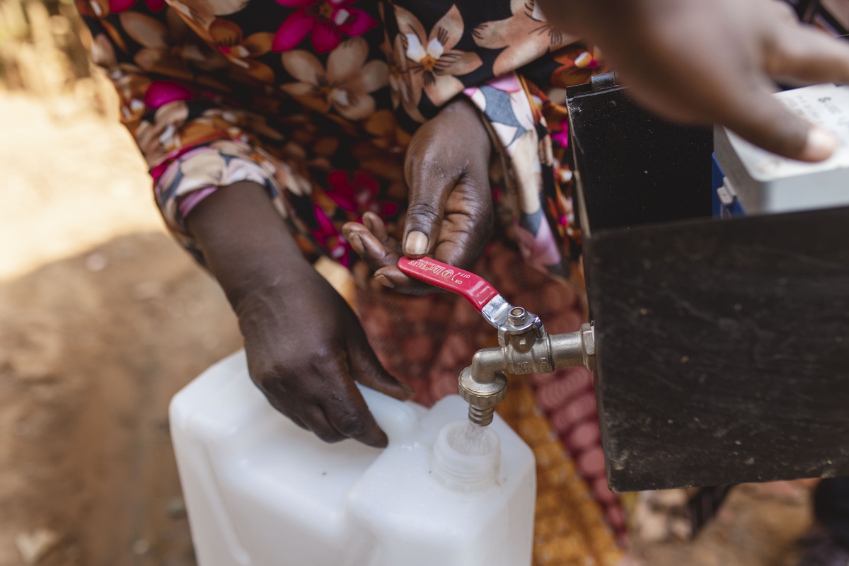 A resident fetches water from a tap installed under BRALIRWA’s initiative to improve access to safe and reliable water for more than 200 househo
