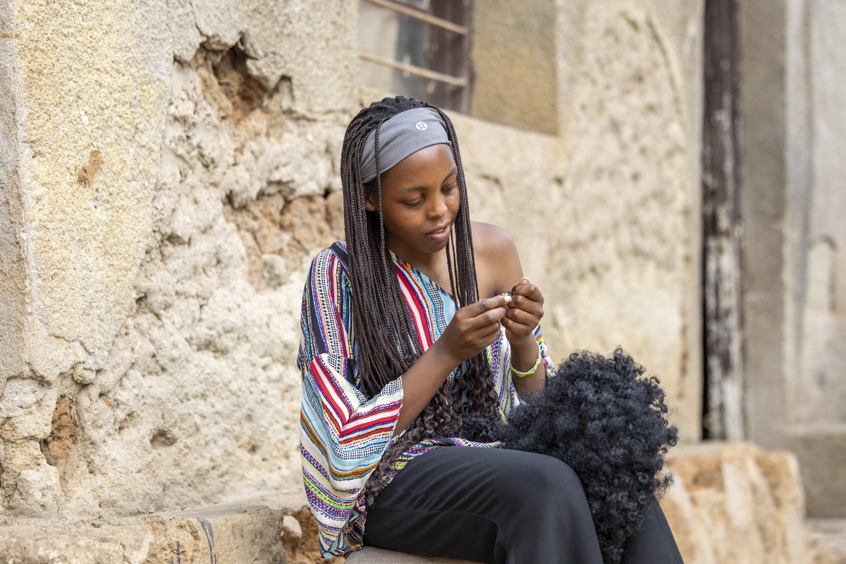 When she’s not working or doing household chores, Uwikuzo makes handmade human-hair wigs, a skill she taught herself.