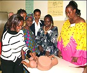 Second from right is Dr. Kagia training women on how to deliver a baby who is stuck by the shoulders. (Photo. F. Mutesi)