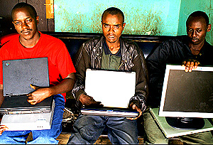 END OF THE ROAD: L-R: Sixbert Ngarukiyintwari, Erneste Niyonambaza aka Rubangura and Eric Manzi at Nyarugenge Police Station yesterday, with the laptops and other items they allegedly stole. (Photo/ G. Muramila)