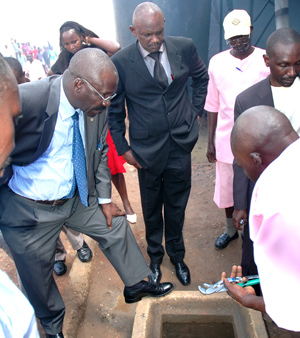Prisoners explain to Byabashaija (left) about biogas system at Remera Prison yesterday, while in the middle, is the Director of Rwanda Prison Services Steven Balinda. (Photo/J .Mbanda)