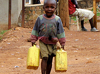 A young boy carries water in Kimisagara, a Kigali city suburb. (Photo/Pascal Manirakiza)